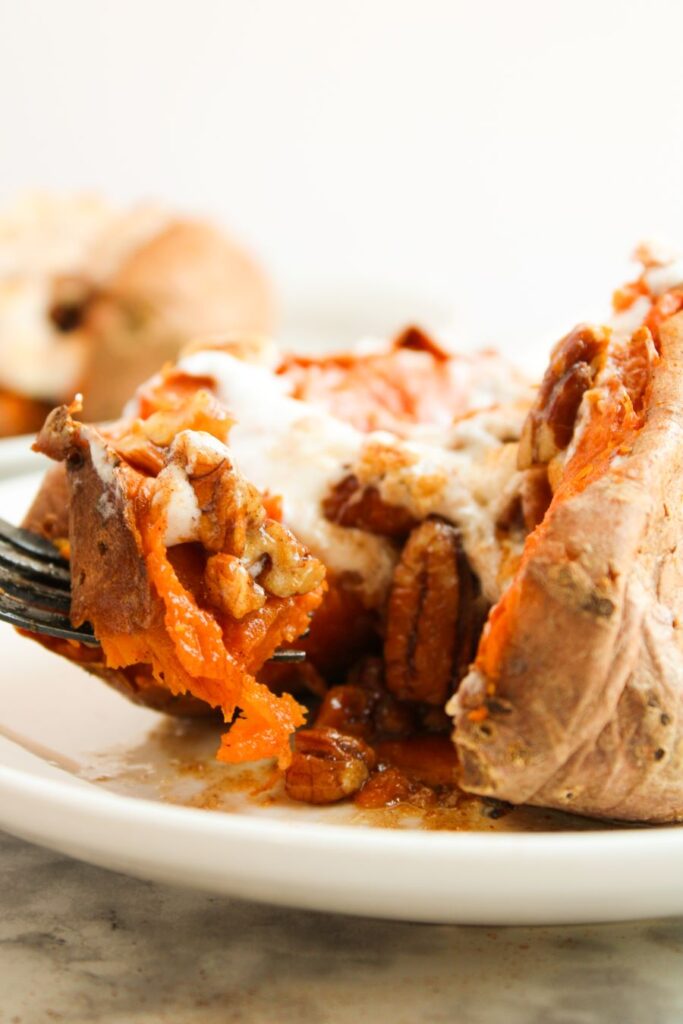 Stuffed Sweet Potatoes close up with a fork scooping some out.