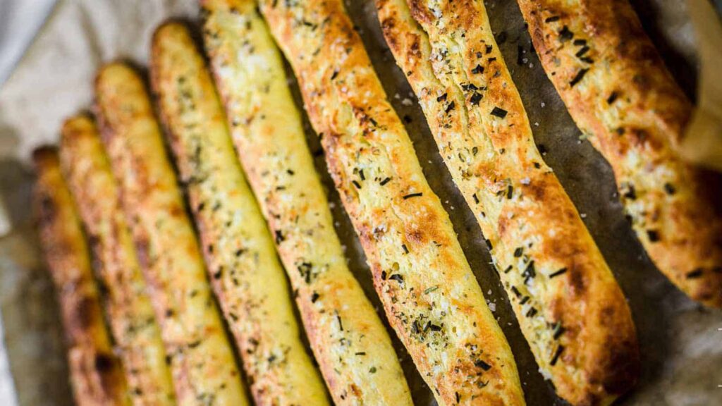 Italian breadsticks on a baking tray.
