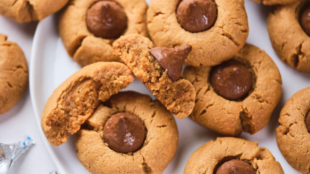 Peanut butter blossoms on a white plate.