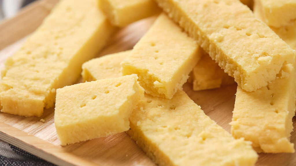 Pieces of shortbread on a wooden board.