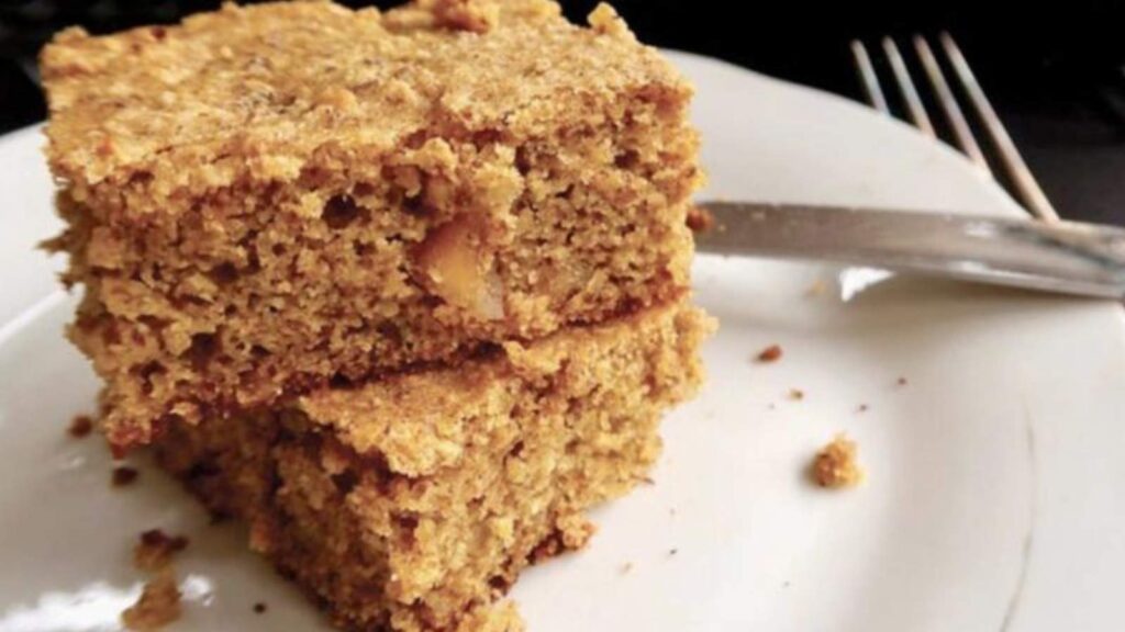 Two slices of coffee cake on a white plate.