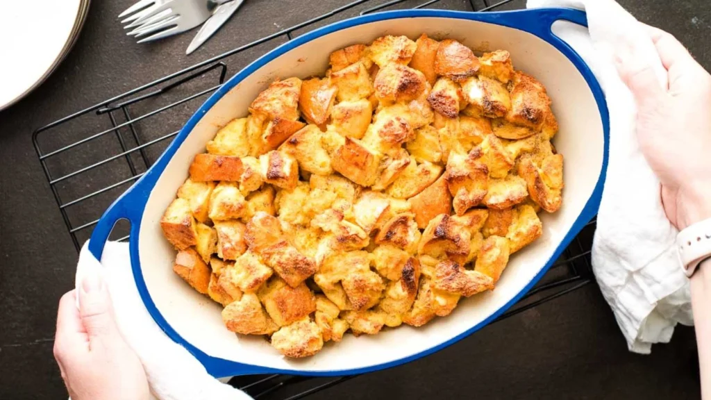 Overnight maple clementine French toast casserole in a white baking dish.