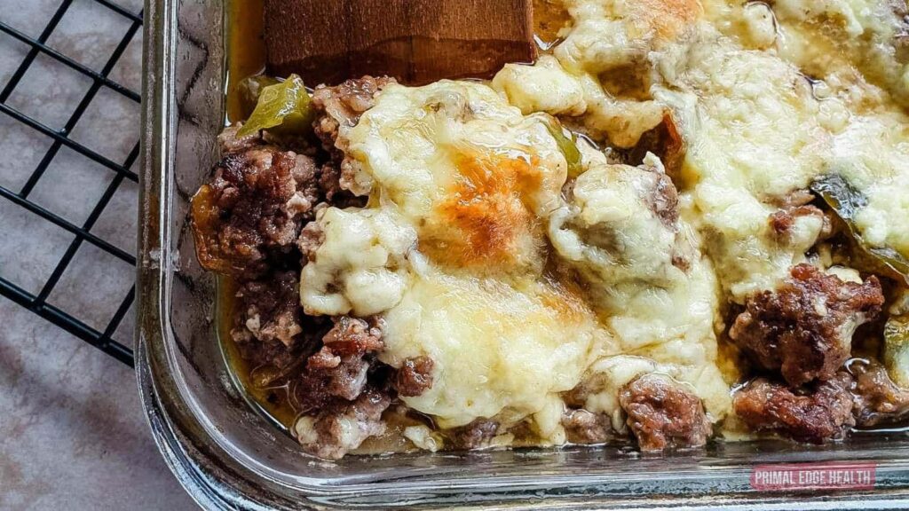 Philly cheeseteak casserole in a glass baking dish.