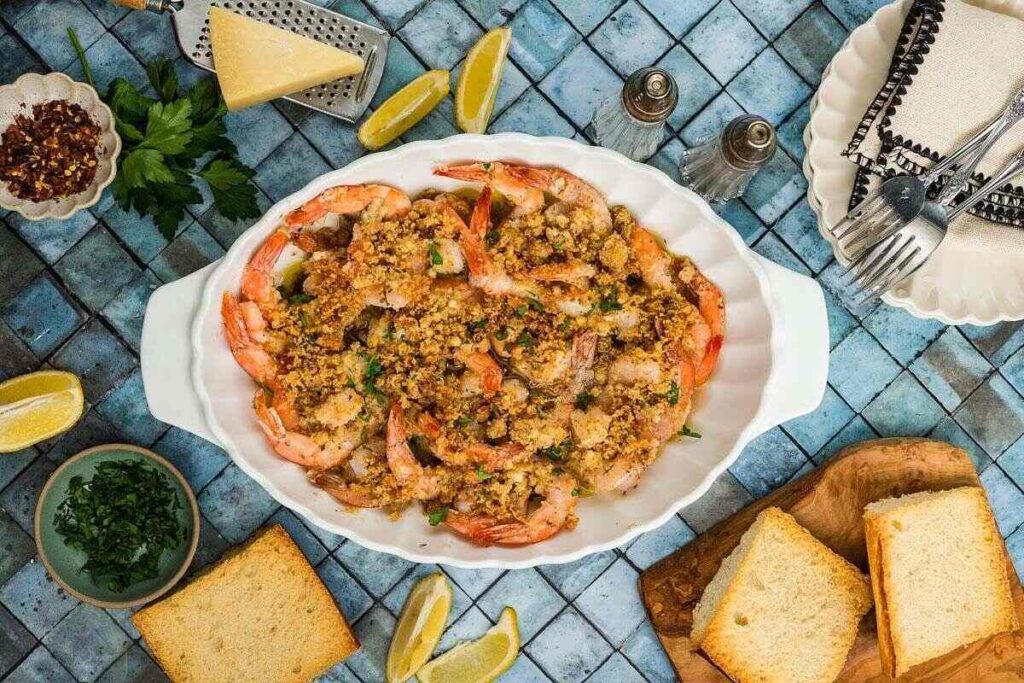 Crispy baked Shrimp Oreganata with breadcrumbs, served with bread, lemon, and fresh herbs.