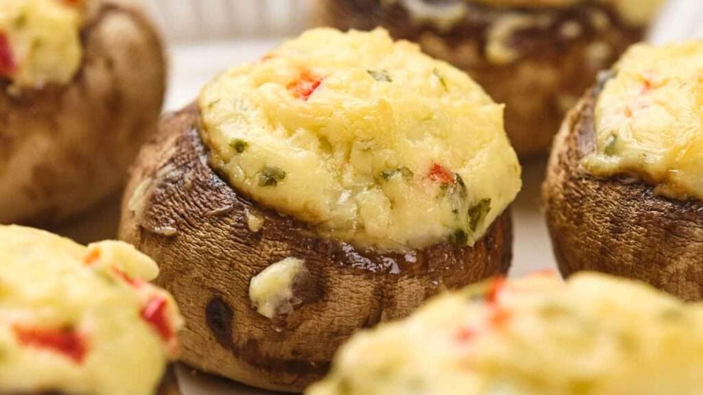 Stuffed mushrooms on a white surface.