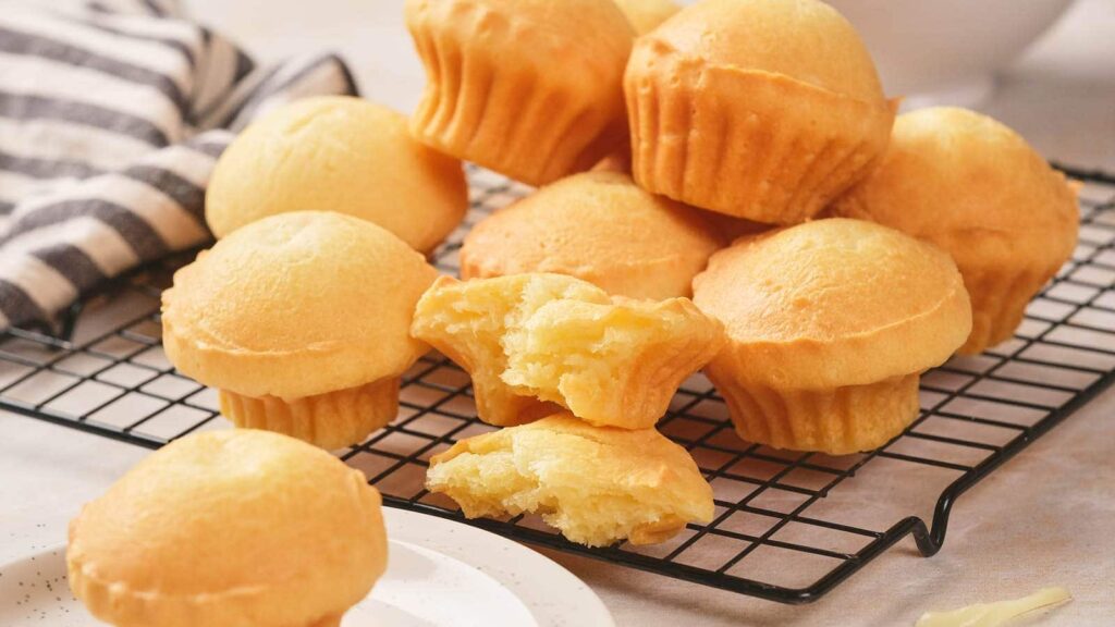 Cheese bread resting on a wire rack.