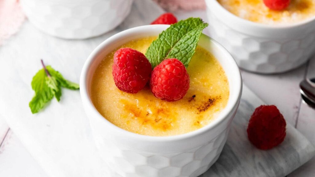 Close-up of creme brulee topped with fresh berries.