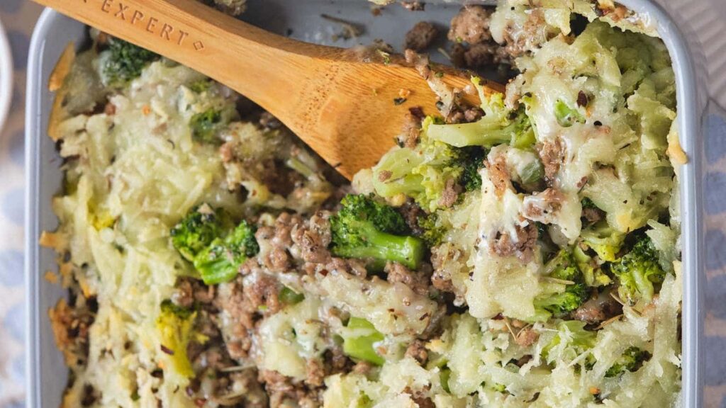Ground beef and broccoli casserole in a grey baking dish,