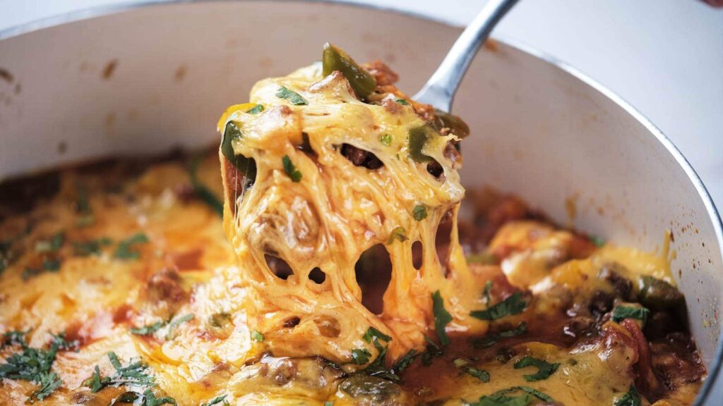 A portion of ground beef taco skillet os being lifted by a spoon.