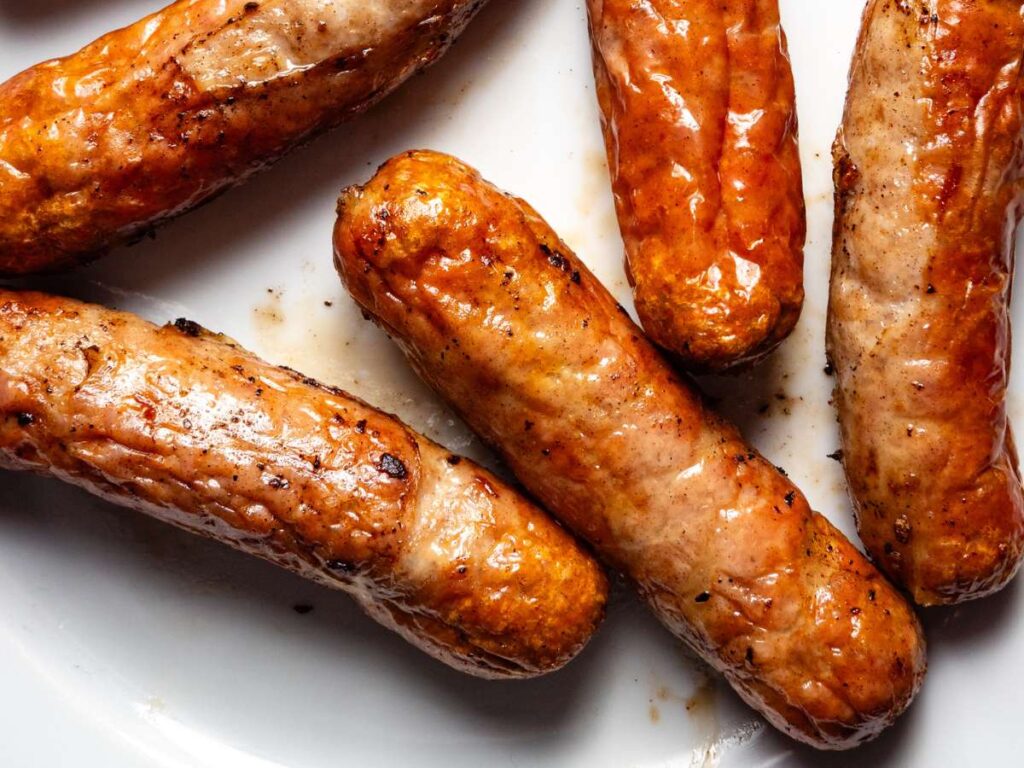 Cooked sausages on a white surface.