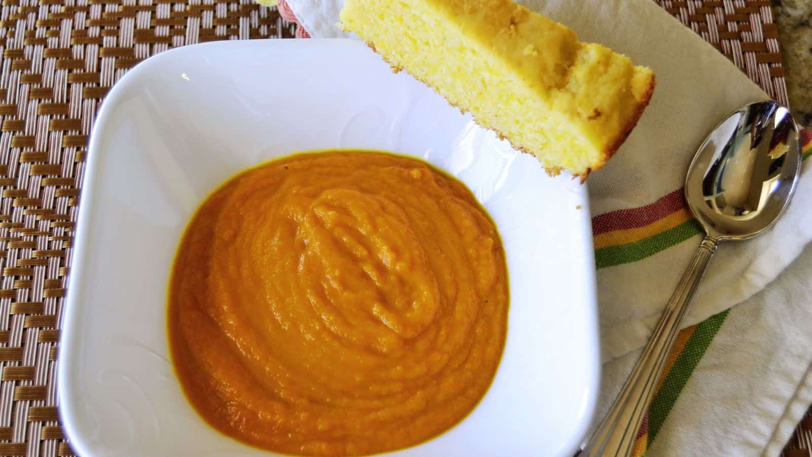 Carrot soup on a white bowl.