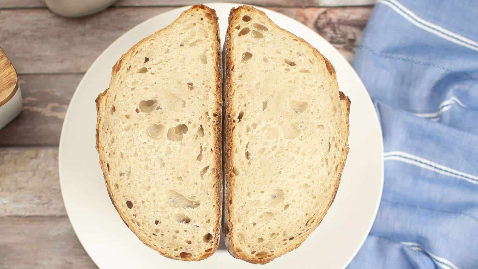 Two pieces of dutch oven sourdough bread on a plate.