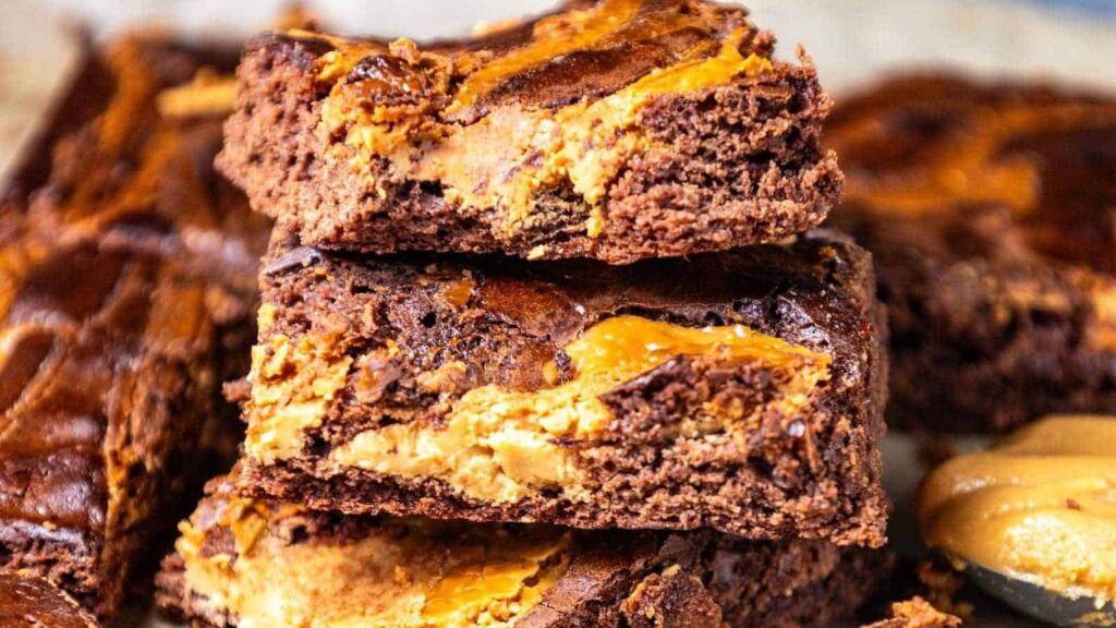 Pieces of peanut butter brownies are stacked together.