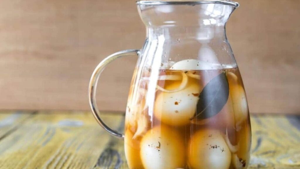 Pickled eggs in a pitcher.