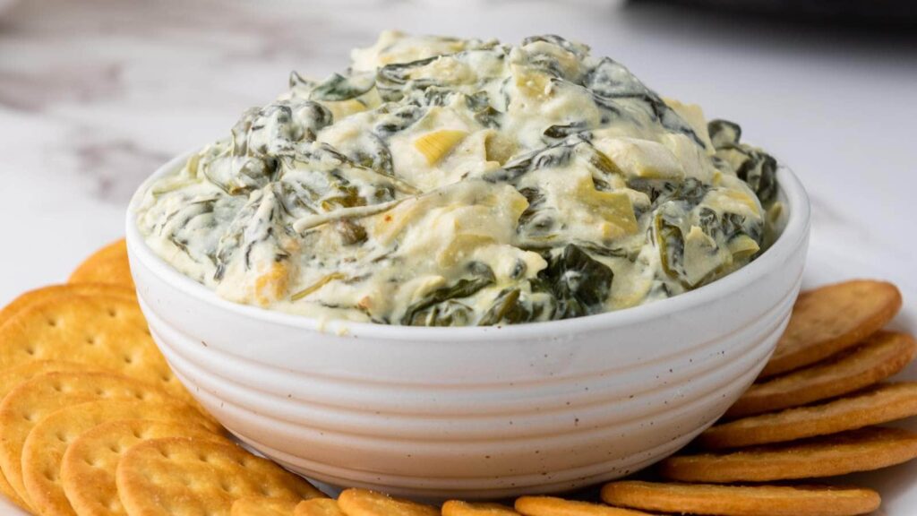 A bowl of spinach and artichoke dip.