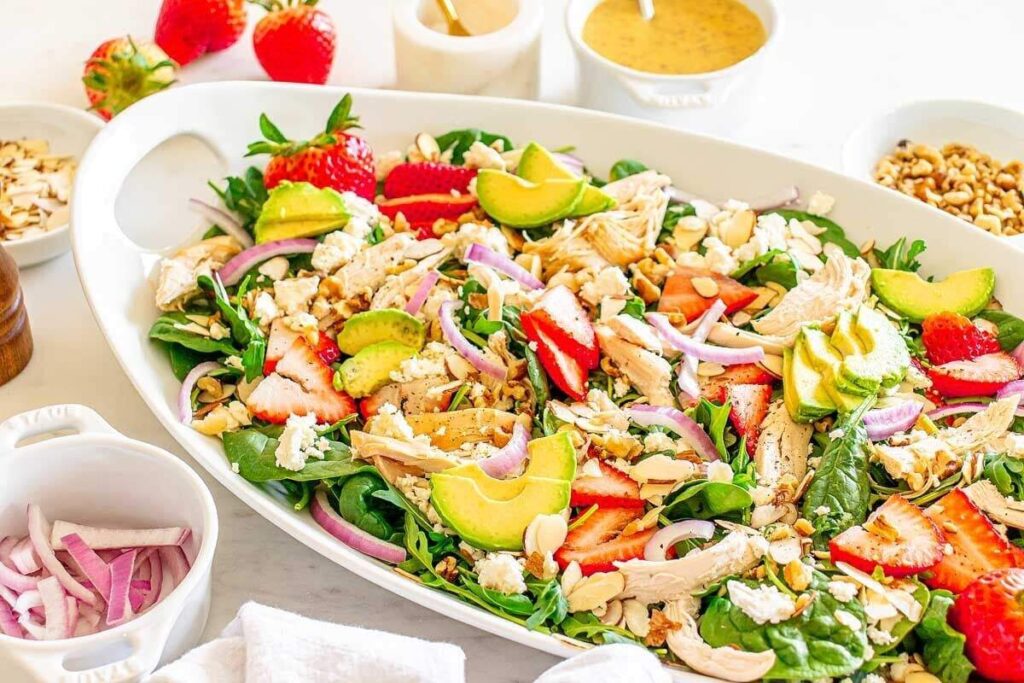 Strawberry Fields salad with fresh greens, fruit, chicken, and crunchy toppings.