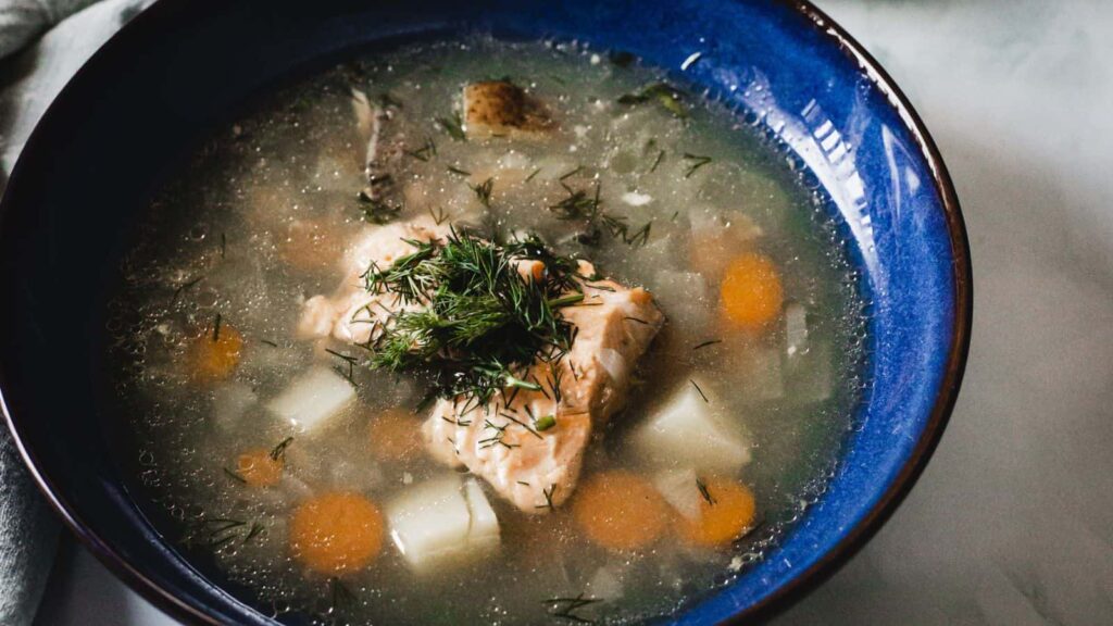 Instant Pot Fish Soup in blue bowl.