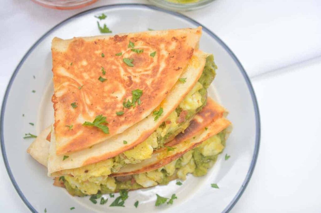 A stack of Breakfast Burritos on a plate.