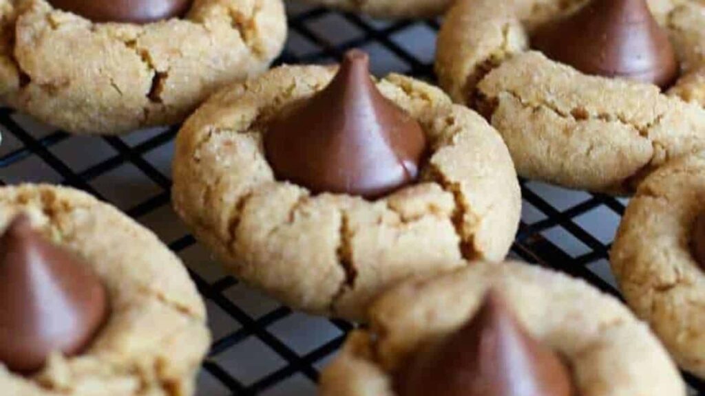 Hershey kiss cookies in rows on a cooling rack.