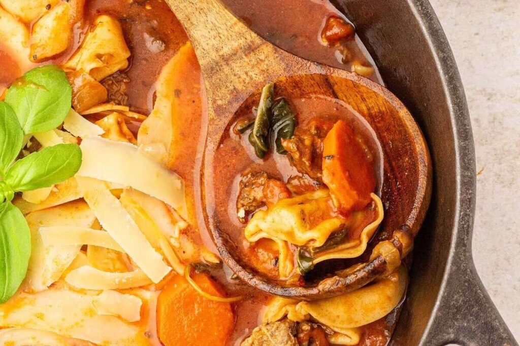 A creamy Italian sausage tortellini soup with noodles, caramelized onions, tomatoes and meat.