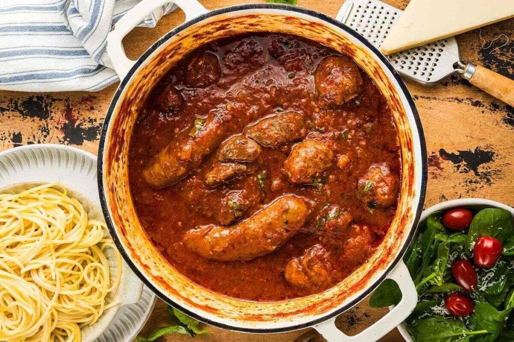 Large pot of Italian sausage in tomato sauce, just like a classic Sunday Sauce.