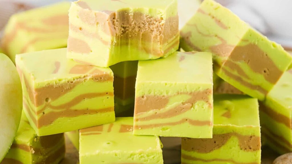 Stack of green and beige striped fudge squares with a bite taken out of the top piece.