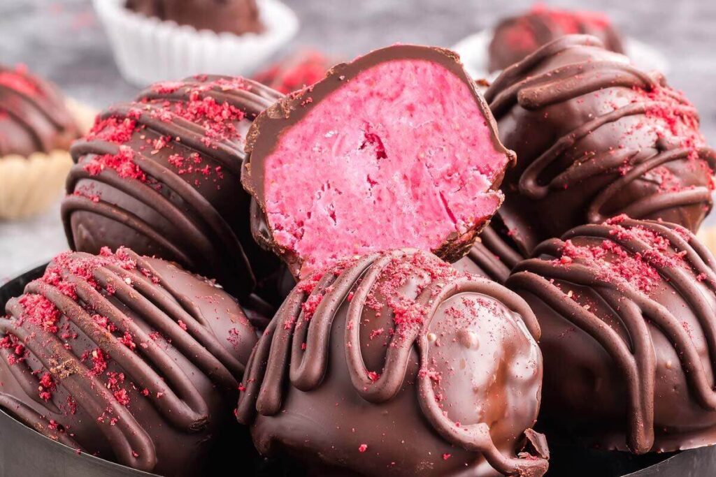 Indulgent chocolate raspberry treats in a black bowl.