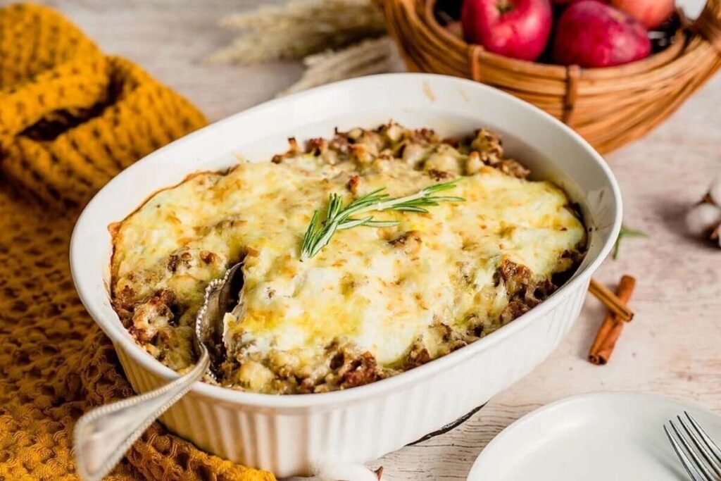 An apple, gouda and sausage breakfast bake in a dish.