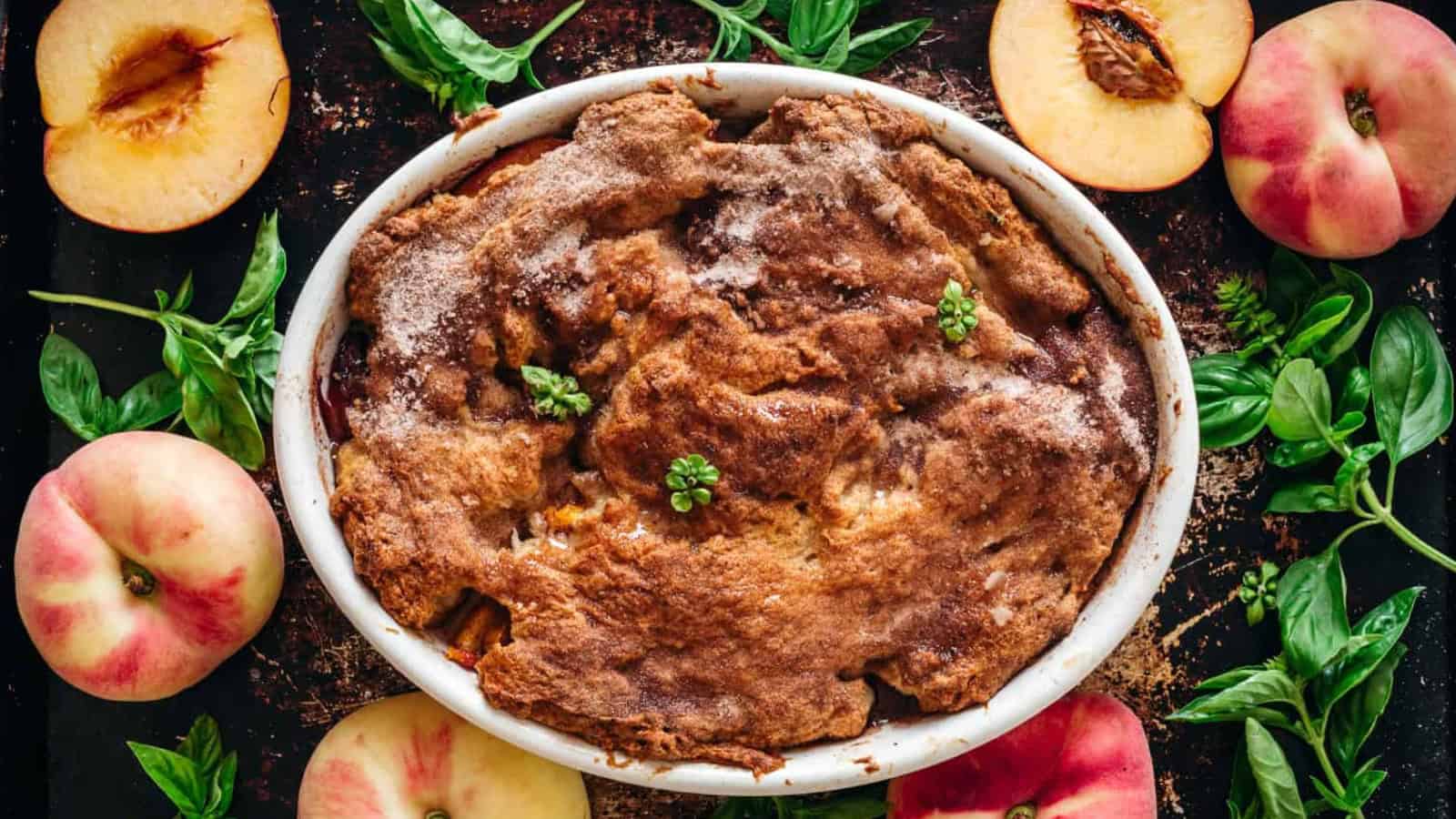 Overhead of peach cobbler on baking sheet.