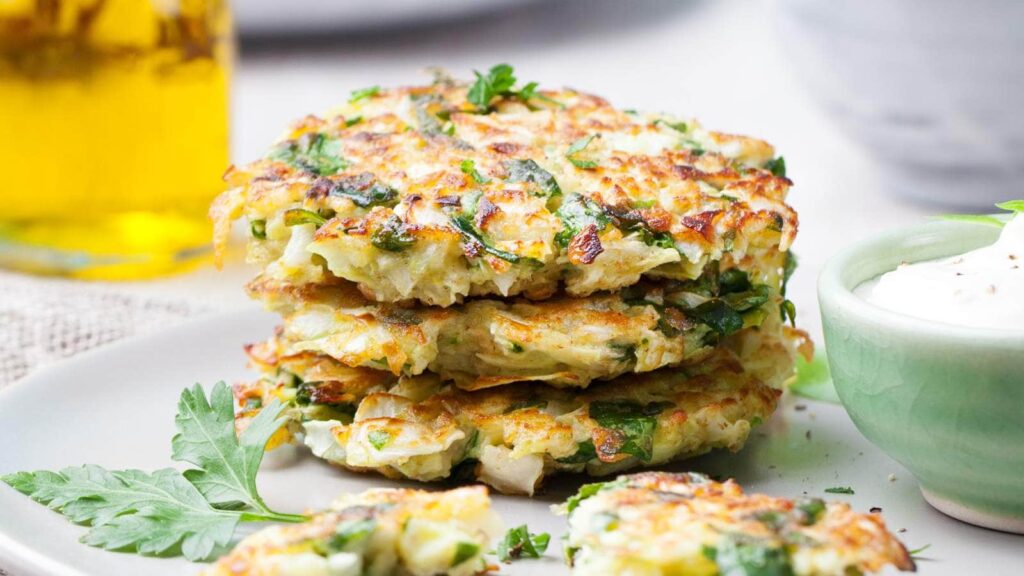 3 pieces of cabbage fritters stacked on top of each other.