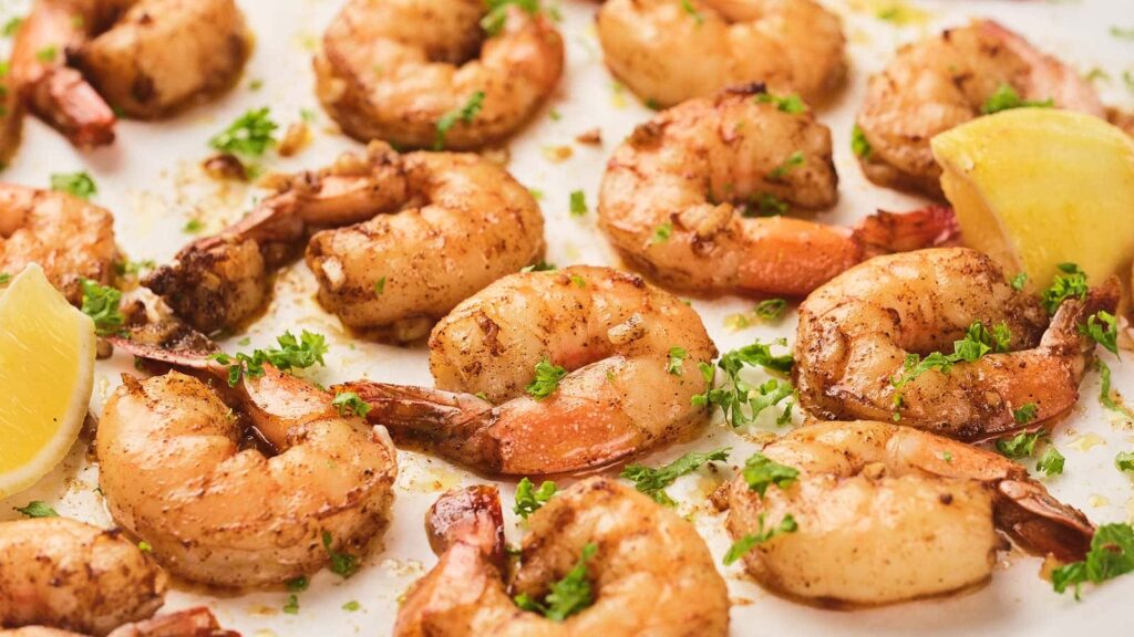 Garlic butter shrimp on a white surface.