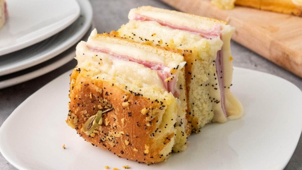 A slice of layered sandwich with ham and cheese.