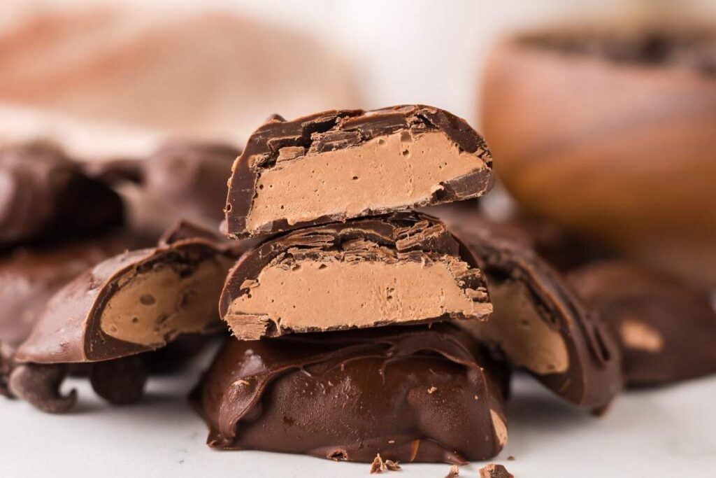 Close-up of chocolate banana bark pieces with a sprinkle of salt on a tray.