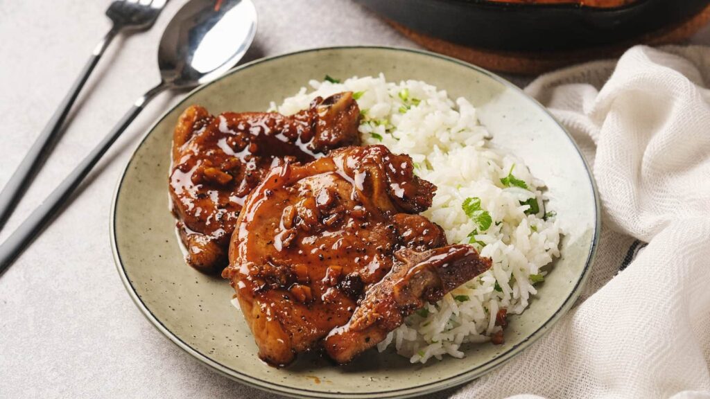 honey garlic pork chops served with rice on a plate.