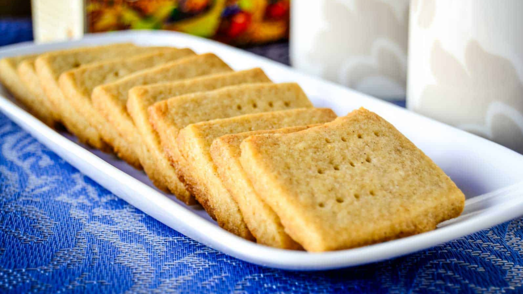 A white plate of a line of Spiced Shortbread Cookies lined up.
