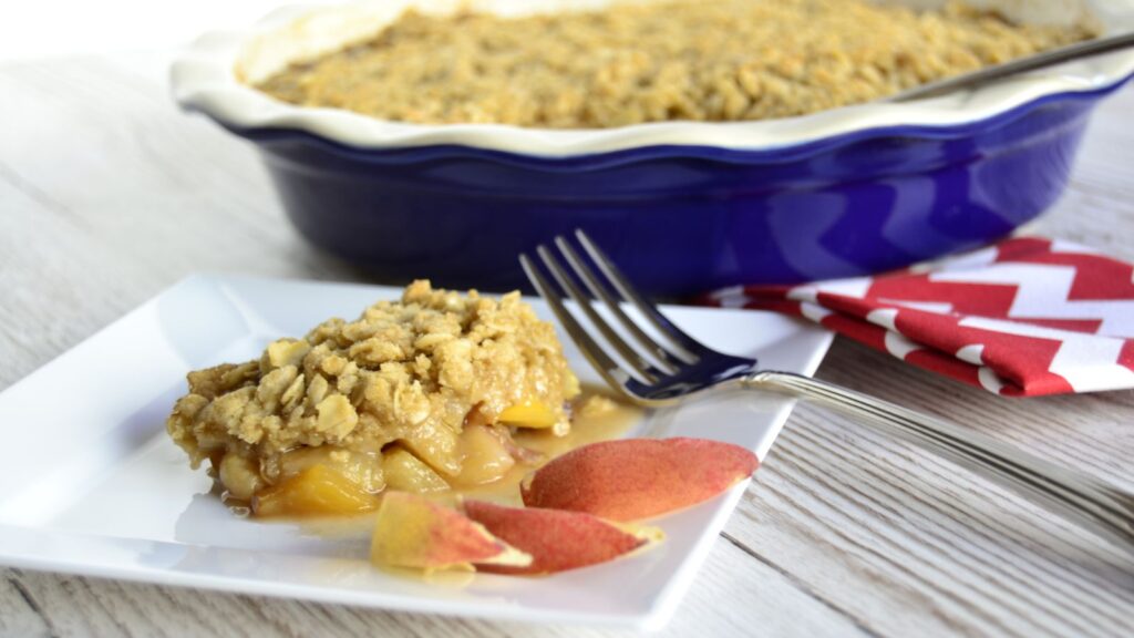 Butterscotch peach crisp topped with juicy peaches.