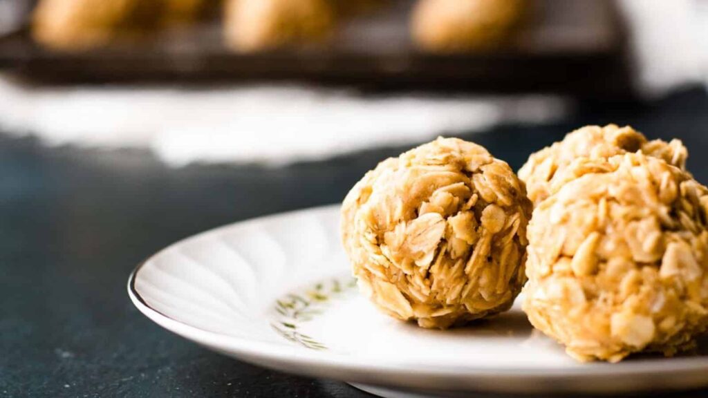 Overhead view of a baking sheet of peanut butter oatmeal balls.