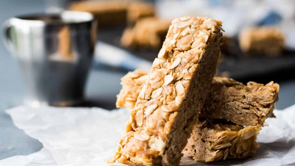 A stack of peanut butter oatmeal bars on a piece of paper.