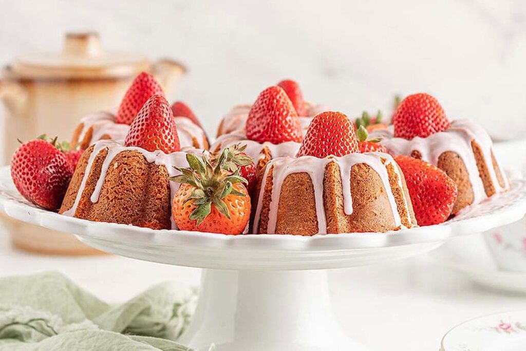 Mini Strawberry Bundt Cakes on a cake platter.