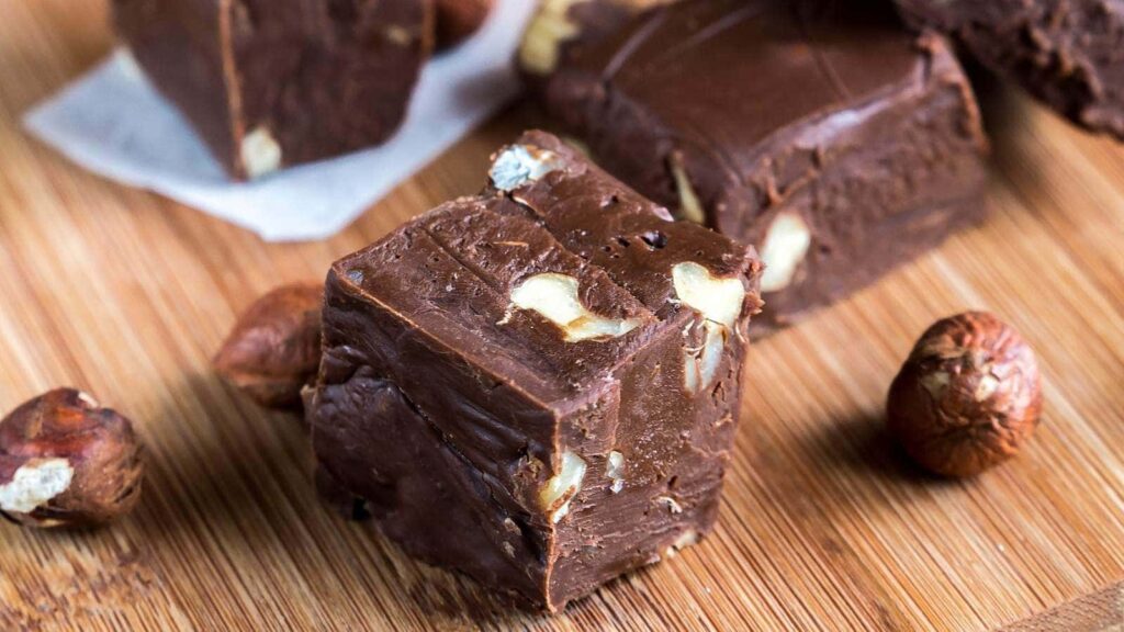 Pieces of nuttela fudge on a wooden board.