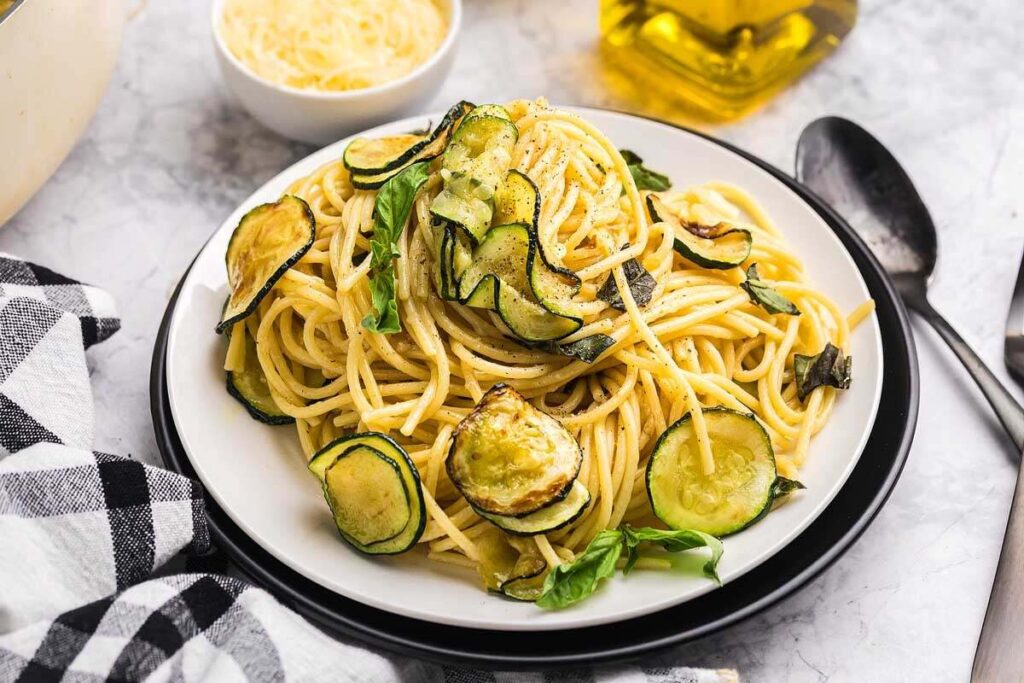 Pasta alla Nerano served with fresh zucchini and herbs.