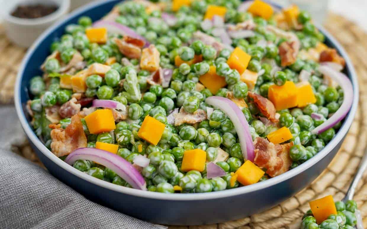 Pea salad in a blue bowl.