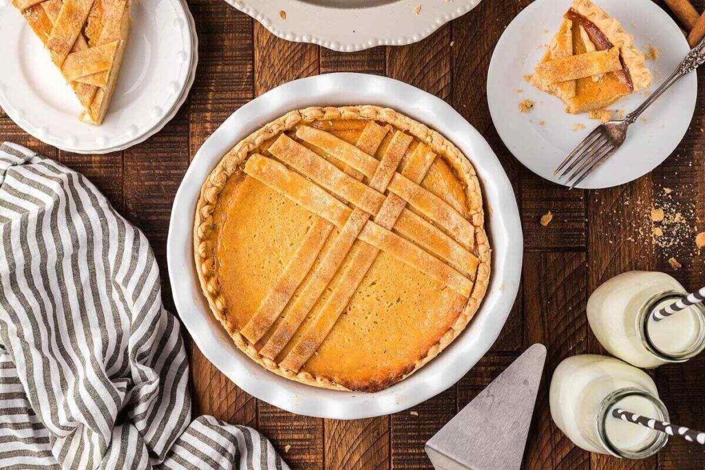 A slice of Sweet Italian ricotta pie on a wooden table.