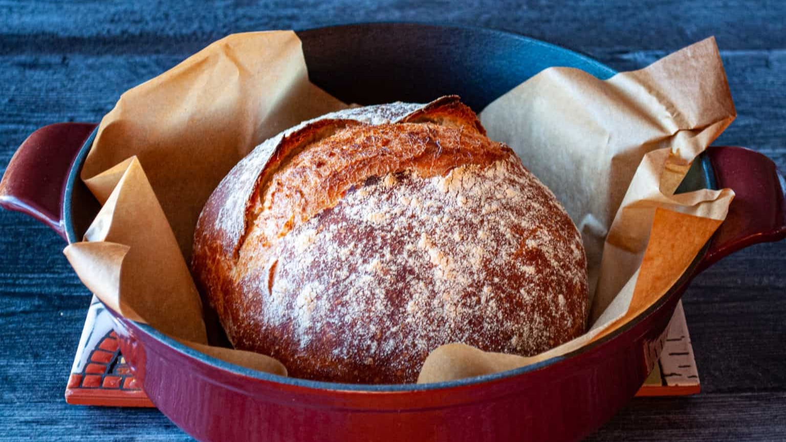 A loaf of Quick Dutch Oven Bread in a braiser.