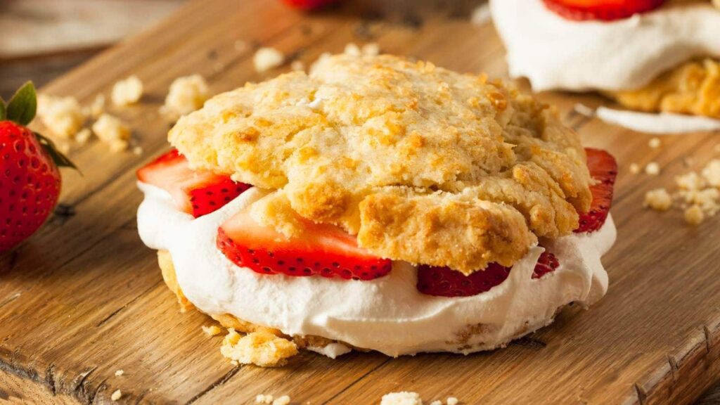 A dessert made with layers of shortcake, strawberries, and whipped cream.