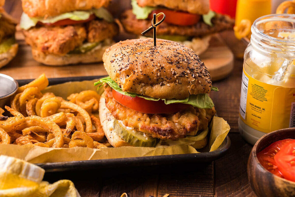 A homemade friend chicken sandwich with fries.