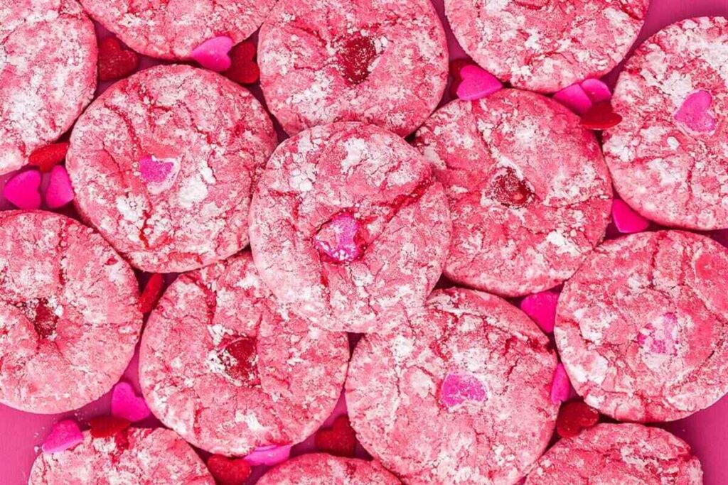 Pink snickerdoodle cookies on a pink background.