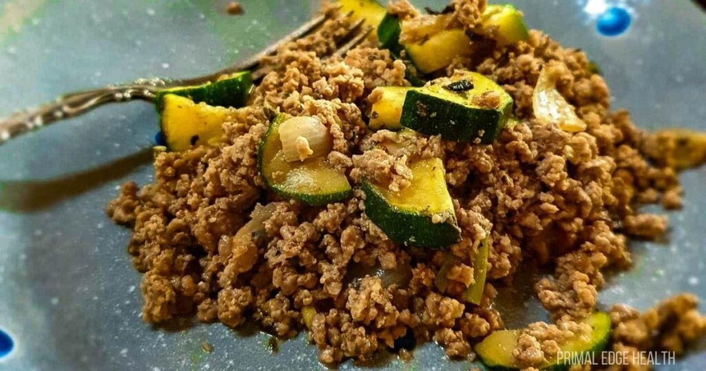 Cooked ground beef with vegetable on a skillet.