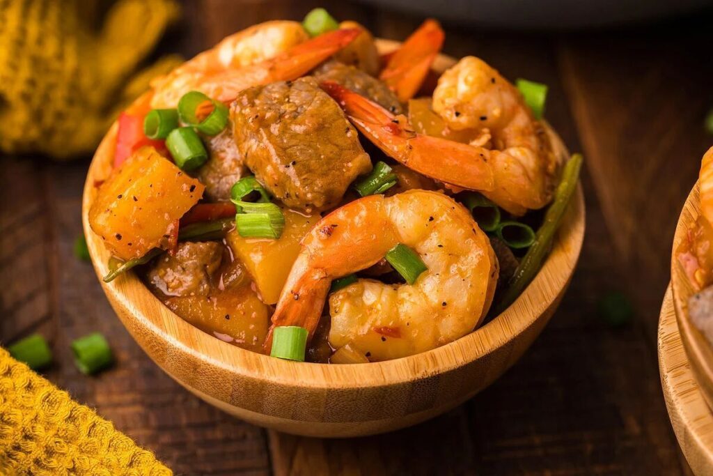 Steak and shrimp in a bowl.