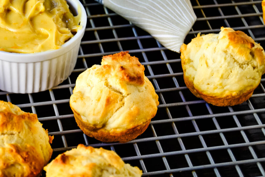 Golden clementine drop biscuits on a cooling rack.